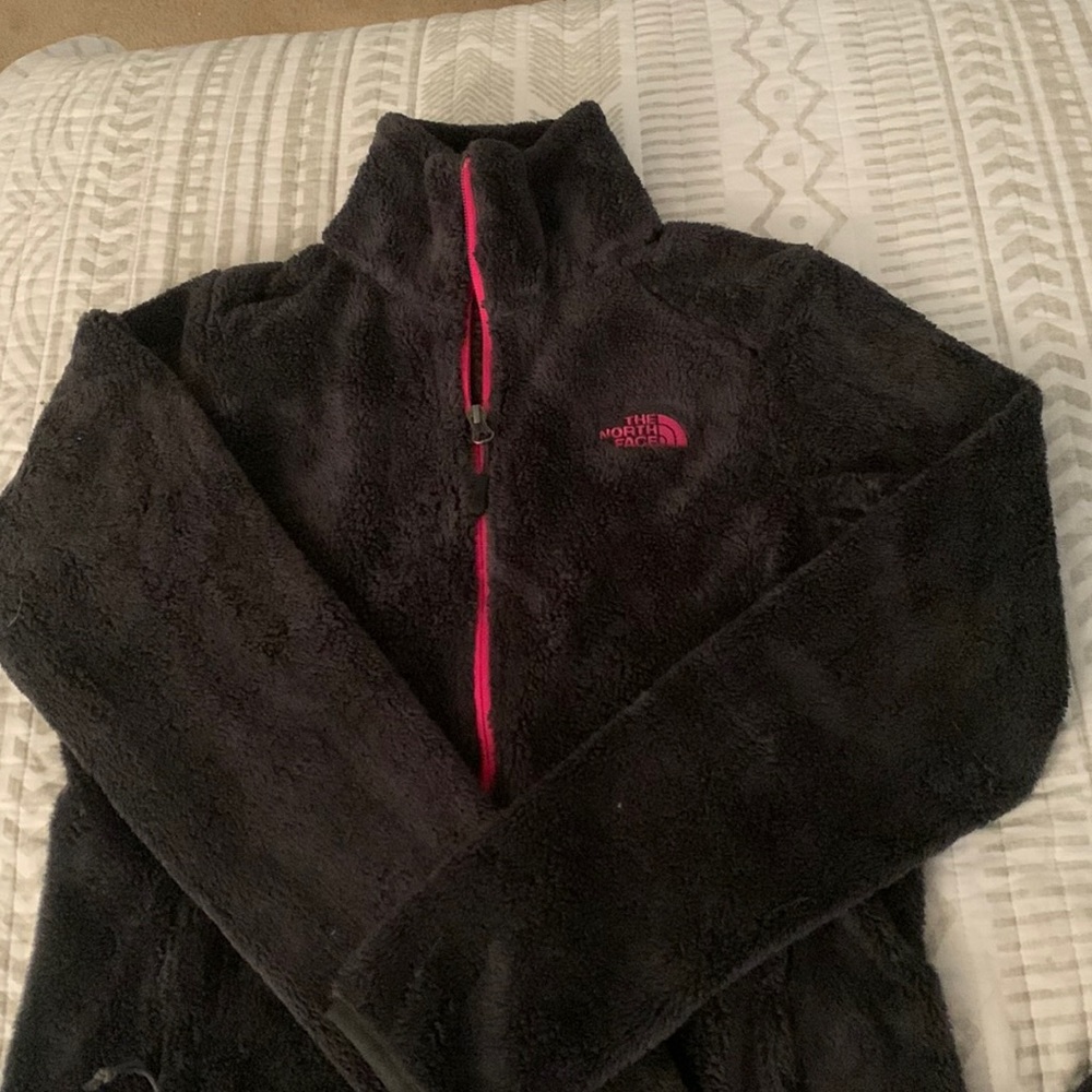 Dark grey north face with pink zipper and logo
